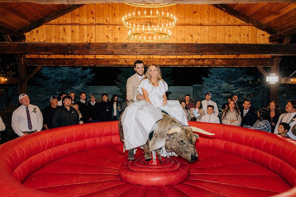 Buck Wild Bride and Groom on Bull - Jackie Siggard Photo + Video - Mechanical Bull Riding Rental Wedding Vendor