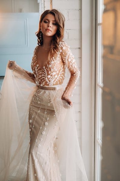 A luxurious bride in a wedding dress in the morning in her interior