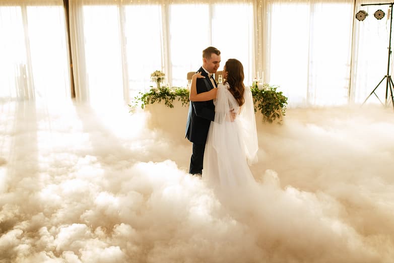 the first dance of the bride and groom inside a restaurant