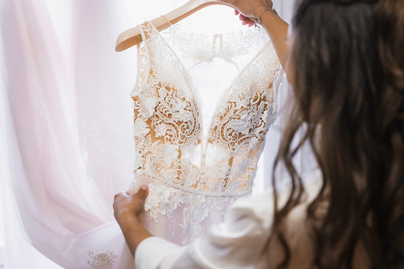 Nervous bride holding wedding dress before ceremony