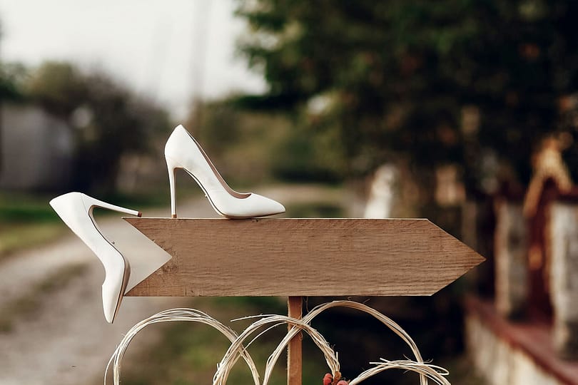 beautiful-white-shoes-on-wooden-arrow-with-space-f-2023-11-27-05-24-26-utc