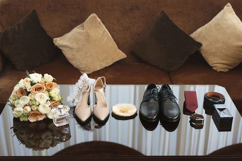 top-view-of-bride-and-groom-shoes-floral-corsage-2025-01-10-20-37-16-utc