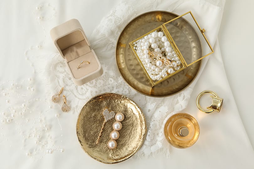 Wedding jewelry and lace on white background, top view