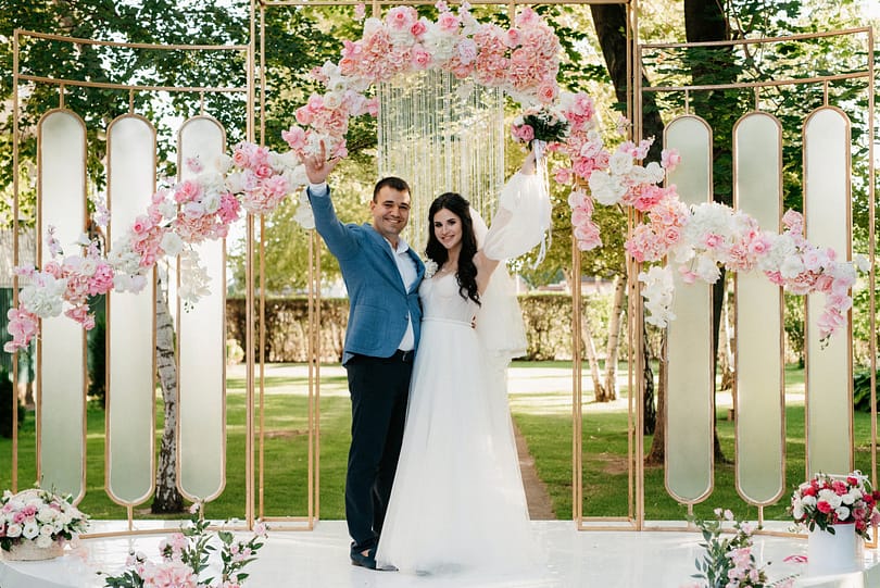wedding ceremony of a guy and a girl in a green park on wedding